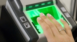 Person having fingers scanned on the fingerprint scanner