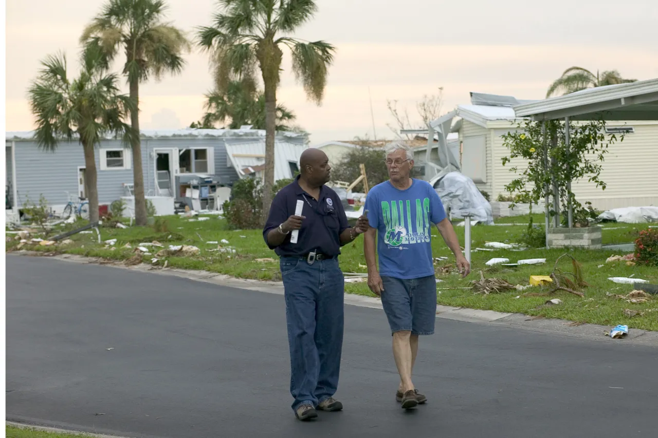 Image: Hurricane Charley - A FEMA employee speaks with a resident whose home was damaged