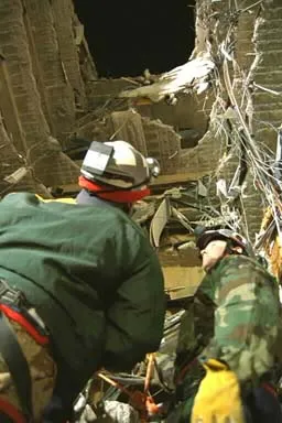 Image: Oklahoma City Bombing - Task Force members look up through the collapsed floors