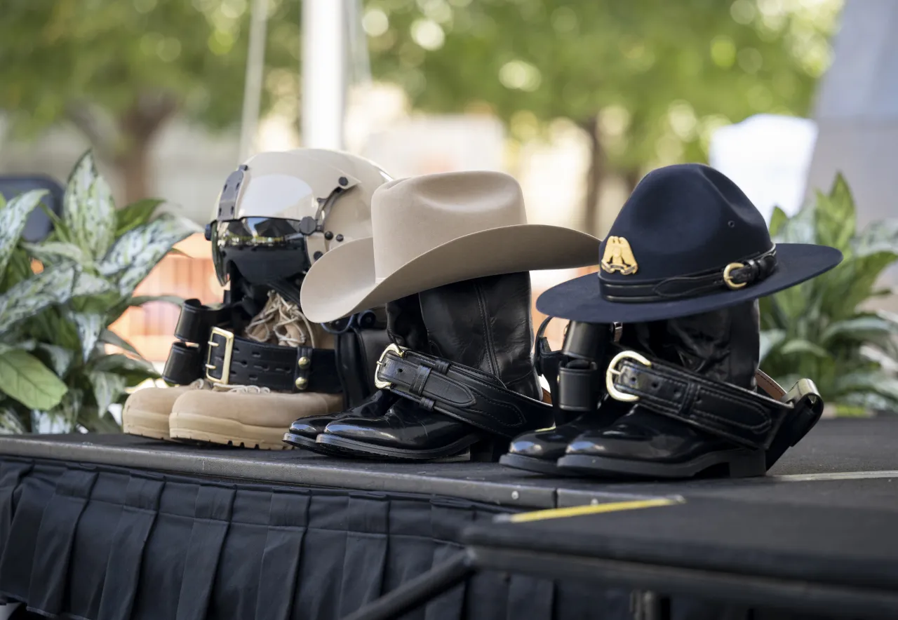 Image: DHS CBP Helmets and Hats Sitting on Pairs of Boots.