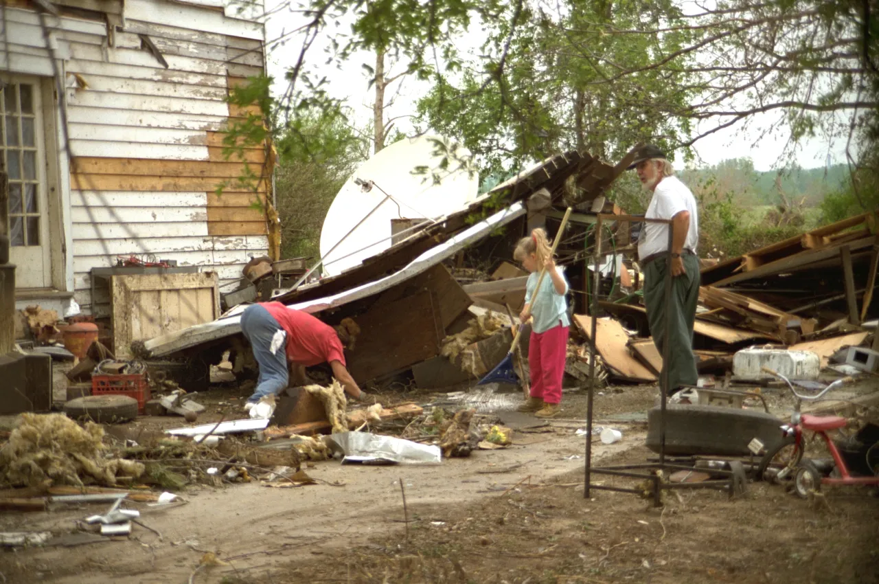 Image: Hurricane Andrew - A young girl cleans up with her family