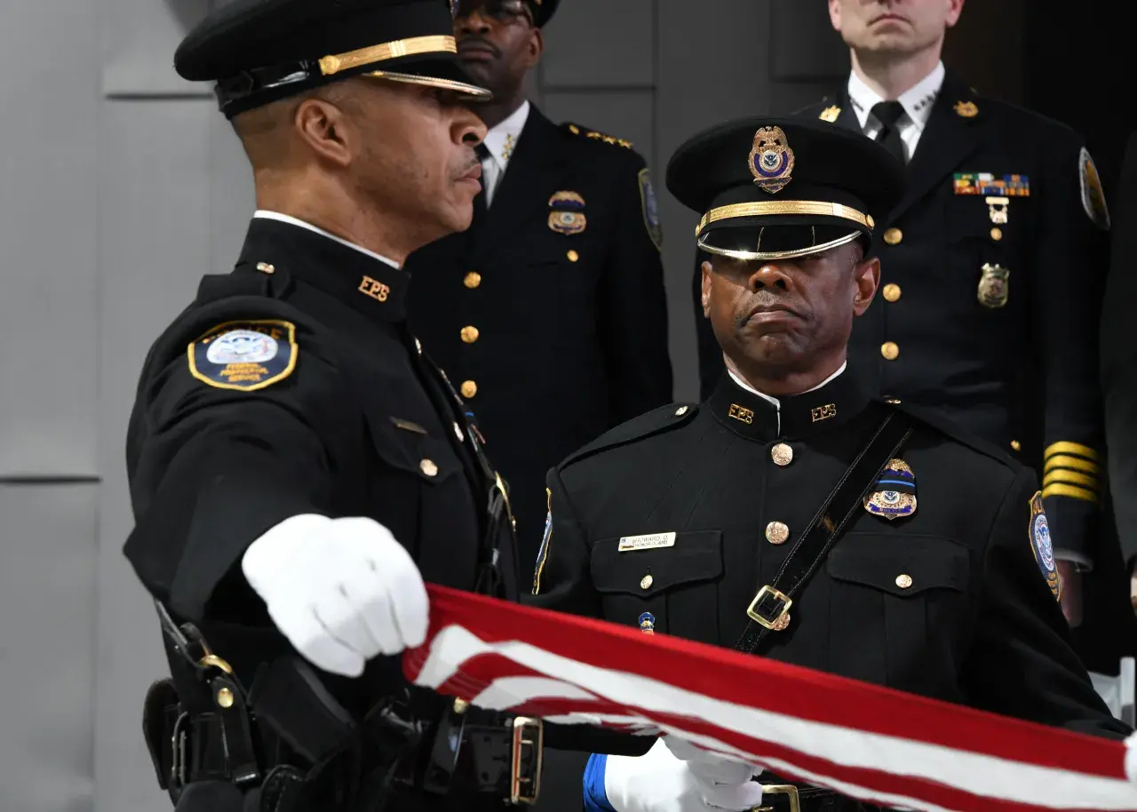 Image: Federal Protection Service (FPS) Officer Folds Flag at Wreath Laying Ceremony