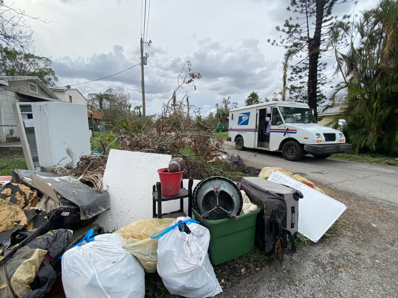 Image: US Postal Truck Delivers Mail in a Neighborhood Impacted by Hurricane Ian