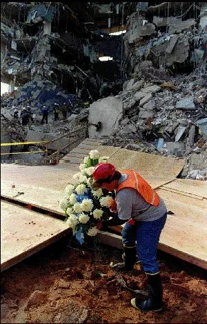 Image: Oklahoma City Bombing - A worker lays a wreath at the foot of the site of the terrorist attack