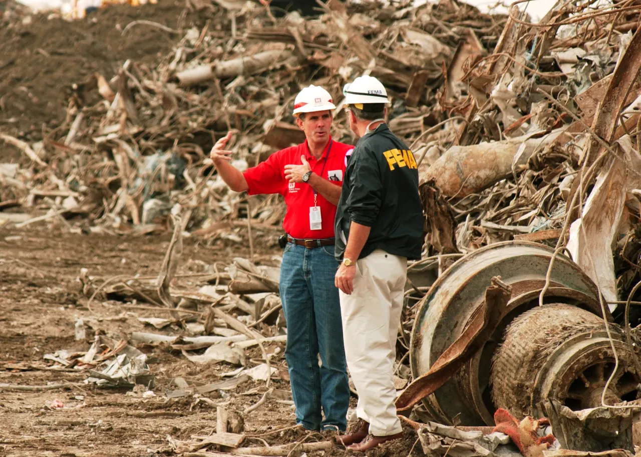 Image: 9/11 A FEMA Official receives briefing on the recovery operations at Ground Zero from Army Corps of Engineers member