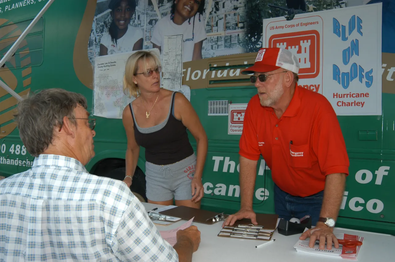 Image: Hurricane Charley - Army Corps of Engineers speak with a resident