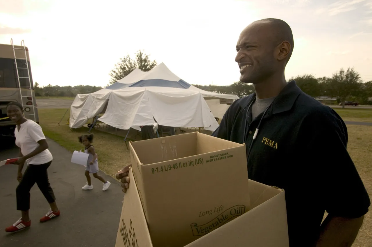 Image: A FEMA employee assists at a State Disaster Recovery Center