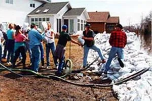 Image: Volunteers work together in a sandbag line