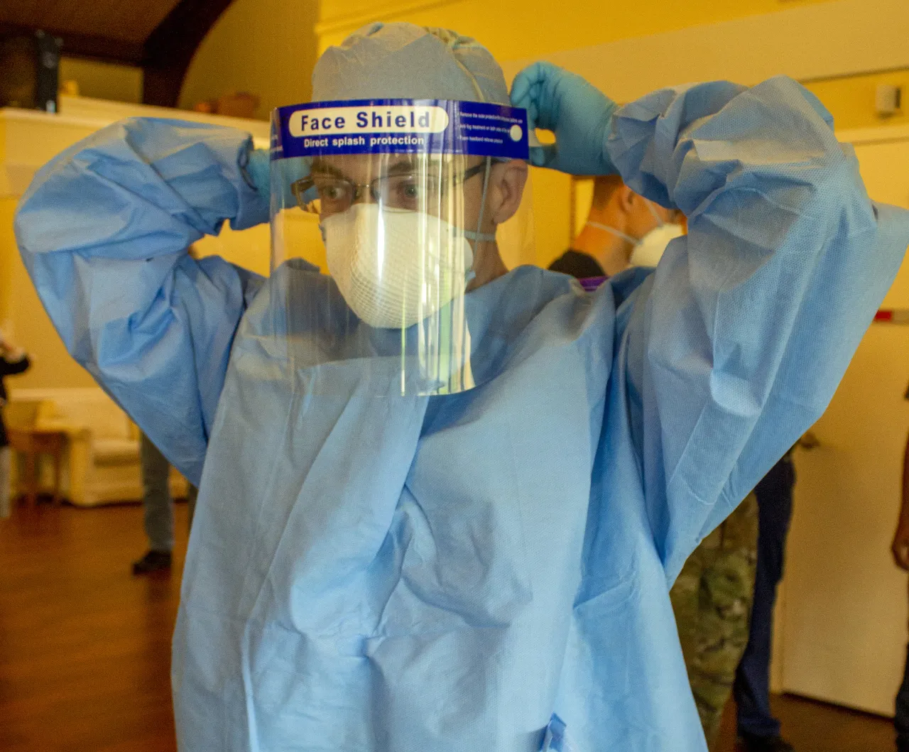 Image: Sgt. Shane Brandes Adjusts His Face Shield at the Lancashire Hall Nursing and Rehab Center