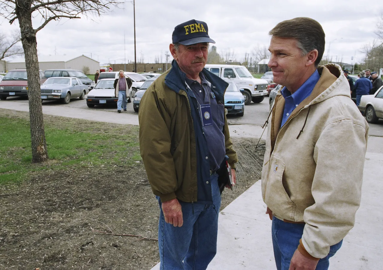 Image: Director Witt speaks with a FEMA employee