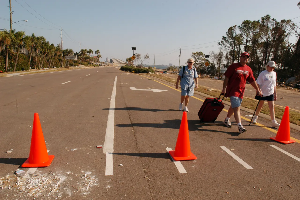 Image: Hurricane Ivan - Local residents who were able to go into the area impacted by the hurricane leave with some personal belongings