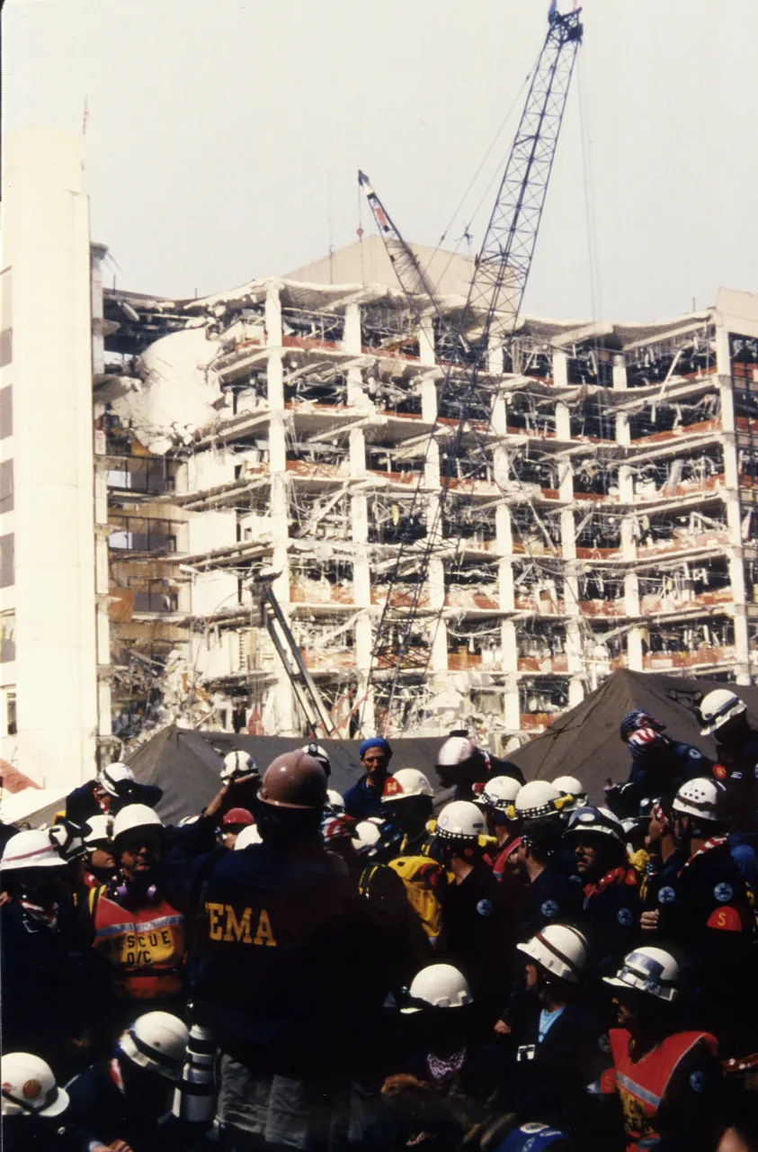 Image: Oklahoma City Bombing - Search and Rescue workers gather outside