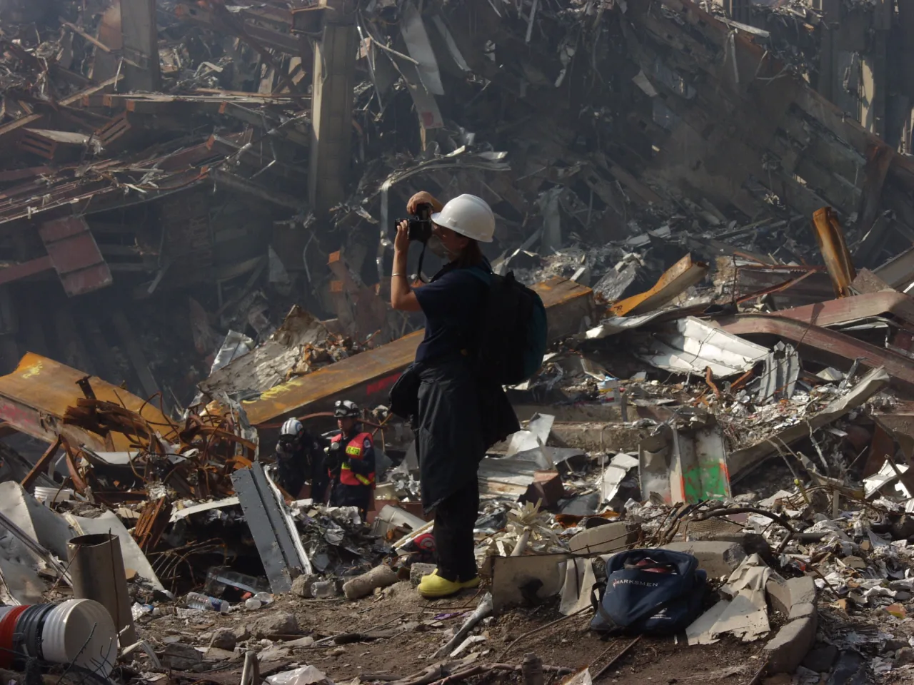 Image: 9/11 - A photographer pauses to take a picture of the recovery operations underway at the World Trade Center