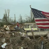 Image: Hurricane Andrew - The flag stands tall amongst rubble