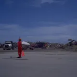 Image: Hurricane Andrew - A worker stands ready to direct vehicles for cleanup