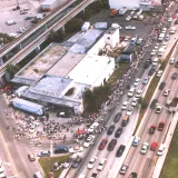 Image: Hurricane Andrew - An aerial view of disaster victims line up at a semi trailer to receive ice