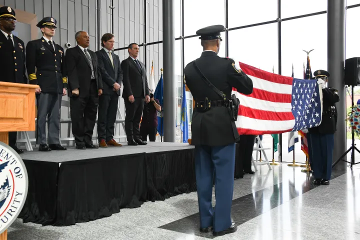 Image: Two Federal Protection Service Officers Fold American Flag at Wreath Laying Ceremony