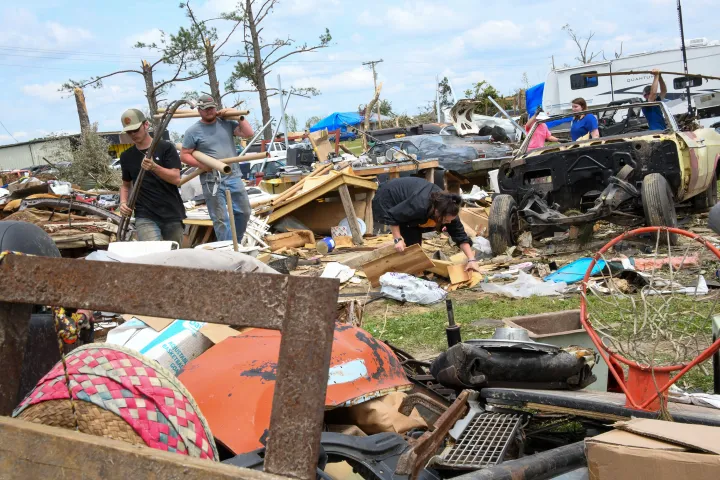 Image: People Walk Through Mississippi Tornado Aftermath Rubble