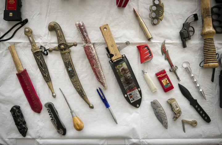 Image: Small Weapons Such as Knives and Daggers Laid Out on a Table