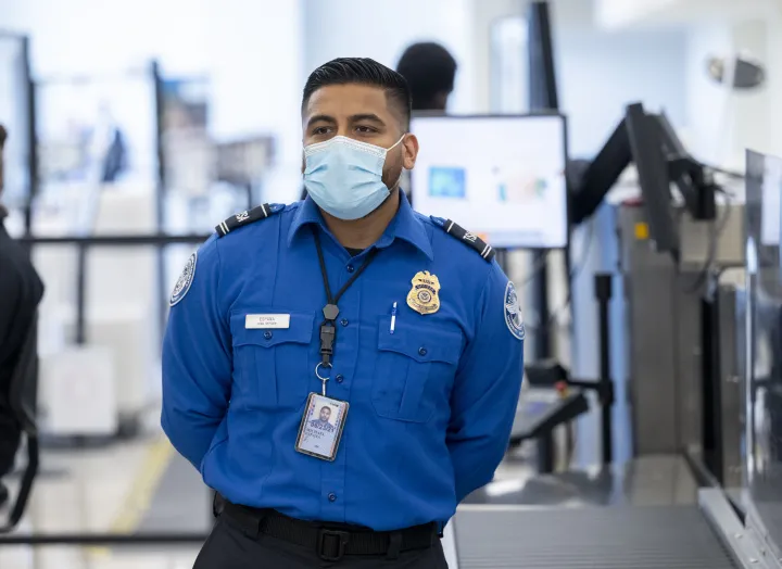 Image: TSA Agent Stands at Airport Security