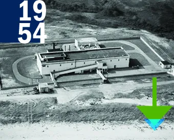 1954. A black and white aerial photo of the original PIADC laboratory building.
