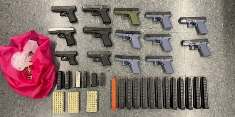 Assault rifles, ghost guns, high-capacity magazines, and ammunition recovered by the investigation