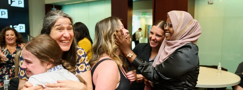 Image of Invent to Prevent finalists hugging after being announced as winners at the I2P competition.