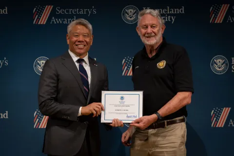 DHS Deputy Secretary John Tien with Team Excellence Award recipient, Kenneth S. McNeil.
