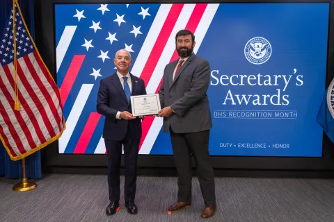 DHS Secretary Alejandro Mayorkas with Innovation Award recipient, Luke D. Watko.