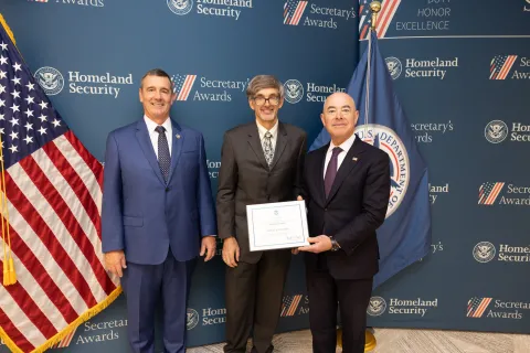 Left to right: Transportation Security Administration (TSA) Administrator David Pekoske, Innovation Award recipient John M. Blackadar Jr., and DHS Secretary Alejandro Mayorkas.