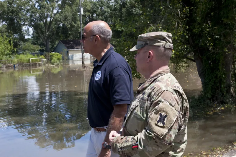 Secretary Johnson and member of U.S. Army National Guard look out over flooded area