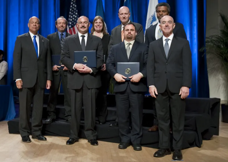 Secretary of Homeland Security Jeh Johnson and Deputy Secretary of Homeland Security Alejandro Mayorkas presented the Secretary's Customer Service Award to members of the U.S. Immigration and Customs Enforcement National Intellectual Property Rights Coordination Center - Report IP Theft Form