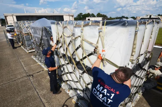 Disaster Medical Assistance Team members secure a cargo net around a pallet of medical supplies on the flight line at Dobbins Air Reserve Base, Ga. Sept. 21, 2017.