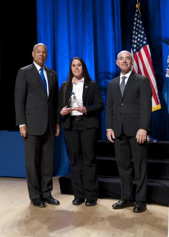 Secretary of Homeland Security Jeh Johnson and Deputy Secretary of Homeland Security Alejandro Mayorkas presented the Secretary's Award for Exemplary Service to Kristie Sandefur