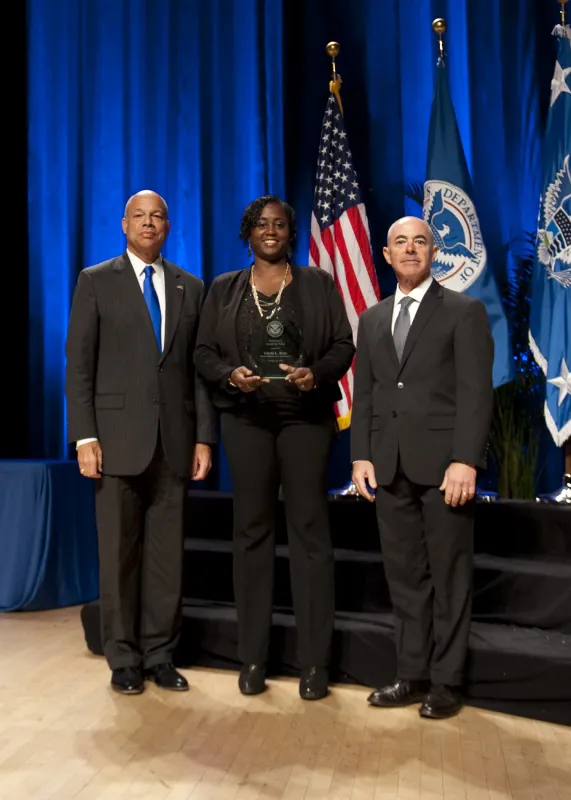 Secretary of Homeland Security Jeh Johnson and Deputy Secretary of Homeland Security Alejandro Mayorkas presented the Secretary's Award for Valor to Gloria L. Betts.