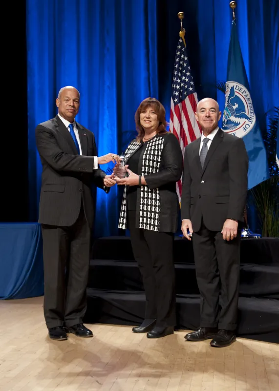 Secretary of Homeland Security Jeh Johnson and Deputy Secretary of Homeland Security Alejandro Mayorkas presented the Secretary's Award for Exemplary Service to Susan M. Bokor.