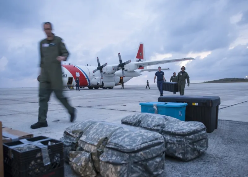 U.S. Coast Guard air crew members deliver medical supplies to support post Hurricane Matthew relief efforts