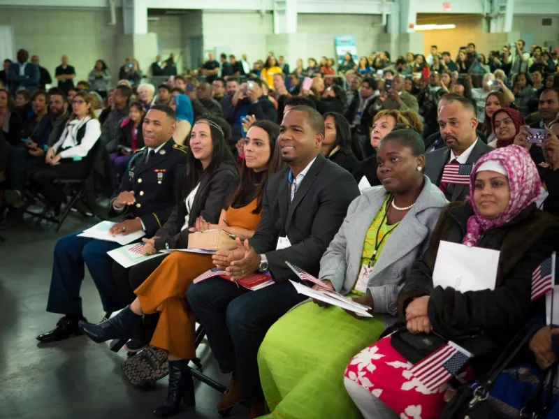 Naturalization candidates listen to New York District Director Phyllis Coven’s opening remarks.