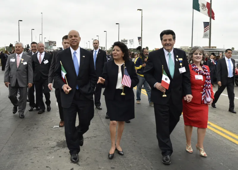 Secretary Johnson walks with others at the International Bridge Ceremony