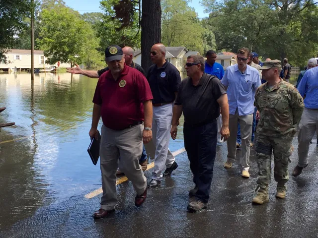 Secretary Johnson being briefed on flooding of Ascension during walking tour