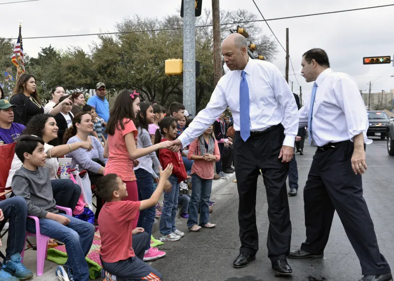 Secretary Jeh Johnson greets children during parade