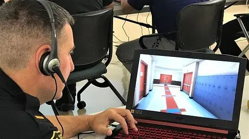 A police officer navigates through the EDGE school environment at a September 2018 training in West Orange, New Jersey.
