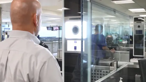 An international traveler stands in front of CBP identity verification camera that uses facial recognition