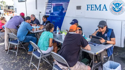 FEMA specialists helps survivors at a Mobile Registration Intake Center