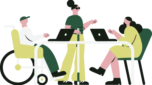 Two women and one man in a wheelchair having a discussion around a table with two laptops on top