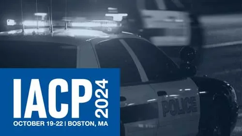 IACP 2024. October 19-22. Boston, MA. A police officer car is in the background.