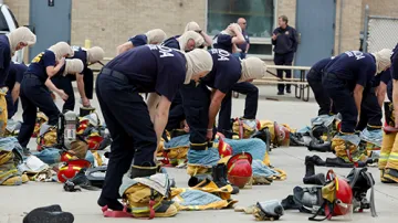 A group of first responders in training putting on their protective gears.