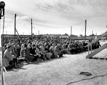 A crowd looking up at the stage Former Secretary of Agriculture Ezra Taft Benson speaks before an audience at the dedication of the newly constructed Plum Island Animal Disease Laboratory in 1956. 