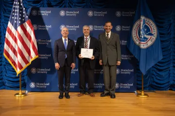 DHS Secretary Alejandro Mayorkas (left) with Team Excellence Award recipient, Patrick Newman (center), and Deputy Under Secretary for Management, Randolph Alles (right).