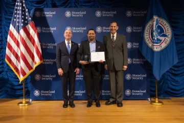 DHS Secretary Alejandro Mayorkas (left) with Innovation Award recipient, Tyrone Huff (center), and Deputy Under Secretary for Management, Randolph Alles (right).